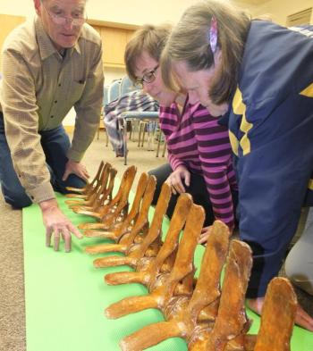 Rick Kopishki, BJ Kopishke and Nattie Kelly work on their section of the skeleton.