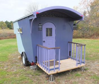 The porch folds up for travel and displays a set of tail lights.