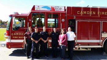 The team of supporters for placing student fire safety messages on the firetrucks include from left, State Fire Investigator Mary MacMaster, Assistant Fire Chief Todd Anderson, firefighters Taylor Benzie and Matt Heath, CRMS Principal Jaime Stone and Camden Fire Chief Chris Farley. (Photo by Sarah Shepherd)