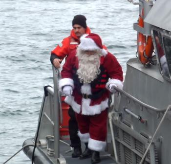 Santa arrives with the help of the U.s. Coast Guard. (Photos by Chris Wolf)