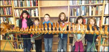 Kyley Leigh, Tanner Kopishki, Lucas Baker, Oscar Malcolm Eastwood Oakes, Abigail Kopishki and Enzo Oakes pose with the pilot whale skeleton they assembled at the Gibbs Library. (Photos by Chris Wolf)