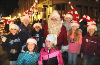 Nothing says the holiday season like Santa Claus, and the Festival of Lights had no shortage of the jolly old guy. He was mobbed by children wherever he went. (Photos by Chris Wolf)