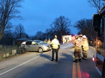 Steve Laite of Camden Exxon begins to remove one of the two vehicles that went through the iron fence and came to rest in Mountain View Cemetery. (Photo by Holly S. Edwards)
