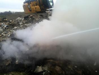 A Sargent excavator helps pull apart the burning pile so firefighters can douse it with water. (Courtesy Rockport Fire Dept.)
