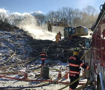 Rockport firefighters are back at the landfill at Mid-Coast Solid Waste along with a Sargent excavator, working to put out the reignited fire from Monday. (Photo by Holly S. Edwards)