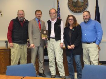 Councilor Larry Pritchett accepts his plaque
