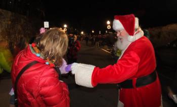 Santa Claus greets the children in Camden Friday night. (Photo by Chris Wolf)