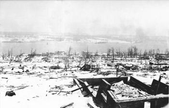 A view across the devastated neighborhood of Richmond in Halifax, Nova Scotia, after the Halifax Explosion, looking toward the Dartmouth side of the harbor. The steamship Imo, one of the ships in the collision that triggered the explosion, can be seen aground on the far side of the harbor, Halifax after December 6, 1917. Nova Scotia Archives and Records Management, Negative Number DNDHfxExplosion-2; Author Unknown wikidata:Q4233718