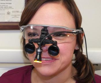 Dental Hygienist Alison Gaeth displays the loupe light purchased from a recent donation by the Camden Rotary to Knox County Dental Clinic.