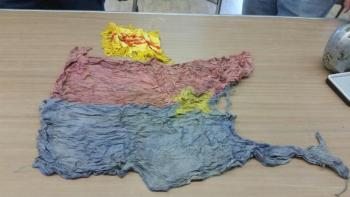 Viet Cong flags from Bob Ogier’s collection. The flags, also known as “flag bombs” were used as decoys. The enemy often rigged the flags with explosives so when US troops took them down, it would set off a charge and kill soldiers. (Photo by Sarah Shepherd)