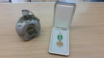 Bob Ogier’s collection of war memorabilia includes a canteen used by a North Vietnamese soldier and his Army Commendation medal. (Photo by Sarah Shepherd)