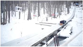 A shot of a fast toboggan coming down the 400-foot-long wood toboggan chute that dates back to 1936 and still has some original timbers in its core structure.