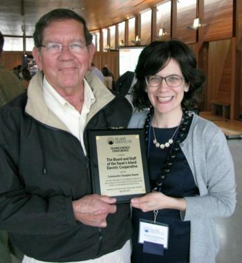 Island Institute Community Energy Director Suzanne MacDonald (right) presented the Community Champion Award to Ed Schwabe, president of the Swan’s Island Electric Cooperative.