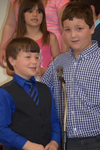 Caleb Downer and Gabe Robertson sing together in “Down By the Bay.”