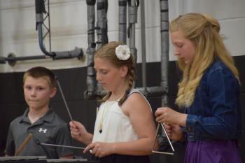 Noah McLellan, Kylee Johnson, and Jillian Barnard lead the percussion section.