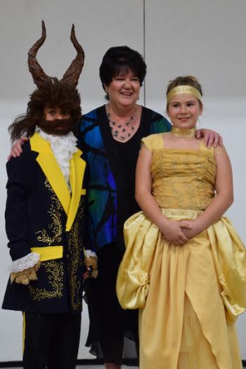 TGS music teacher, Angela Johnson, poses with the Beast (Taygan McAllister) and Belle (Morgan Gehouskey).