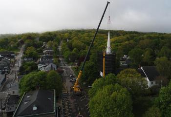 A drone’s view of the early work to secure the spire with cables from the crane that would lift and lower it down onto the street below. (Photo by Todd Anderson)