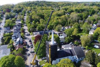 A drone’s view of the early work to secure the spire with cables from the crane that would lift and lower it down onto the street below. (Photo by Todd Anderson)