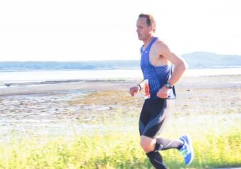 Photographer Dennis Drew aimed directly into the sun to capture marathon winner Robert Ashby near mile two. (Photo by Dennis Drew)