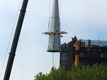 The spire atop the steeple at Chestnut Street Baptist Church in downtown Camden is cut free and lifted by crane Thursday morning. (Photo by Holly S. Edwards)