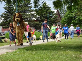 Petey the PAWS dog leads the parade. (photo by Erica Thoms)