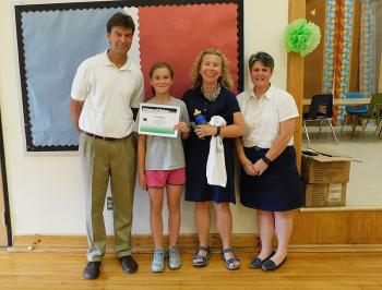 From left, Maine College Circle Director Bob Stuart, fifth-grade winner Erin Robbins and her mother, and Ames Elementary School Principal Lori Smail. (photo by Erica Thoms)