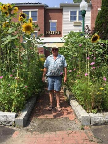 David Dickey, owner of the Camden Riverhouse Hotel, with his trademark sunflowers. (Photo: Jenna Lookner)