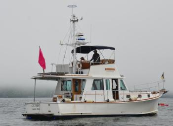Ben Ellison and Gizmo stand duty in the middle of the bay, part of the hundreds of volunteers who make the Islesboro Crossing a success. (Photo by Lynda Clancy)