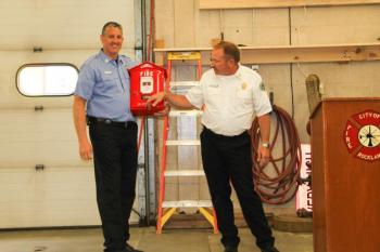 Asst. Chief Elwell (right) presents a retirement gift to Jamie Leo a couple months ago. (Photo courtesy of Rockland Fire/EMS)