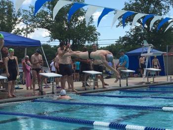 Maine Masters 200+ men’s 400-meter medley relay. Bill Jones (80) finishes fly leg as Pieter DeHart (39) starts anchor free leg. Mike Hurd (49), backstroke swimmer, and Ted Clark (32), breaststroke swimmer, watch. Maine Master Emily Cook observes.