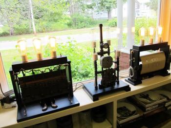 Three steampunk lamps made from salvaged player piano parts, pipefittings, gauges and gears in Tenants Harbor’s store, Stonefish. (Photo by Kay Stephens)