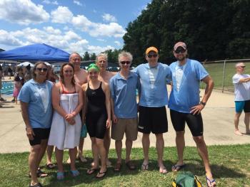 Maine Masters 200+ men’s 400-meter medley relay. Bill Jones (80) finishes fly leg as Pieter DeHart (39) starts anchor free leg. Mike Hurd (49), backstroke swimmer, and Ted Clark (32), breaststroke swimmer, watch. Maine Master Emily Cook observes.