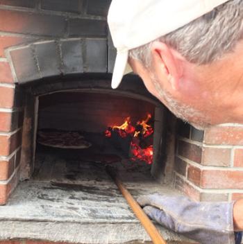 Ken Paquin checks his pies