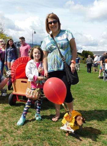 Brandie Cardenas, of Bucksport, poses with her dachshund Dr. Frank-N-Furter and a young friend. (photo by Erica Thoms)