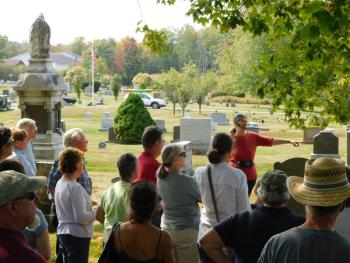 Megan Pinette (facing crowd) leads a tour through Grove Cemetery.
(photo by Erica Thoms)