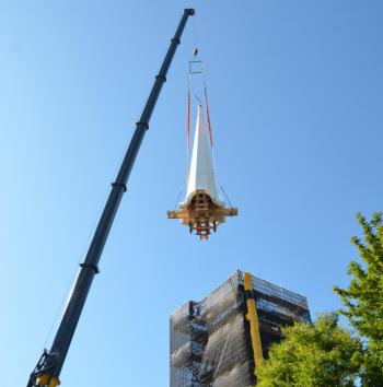 While it took approximately four hours to get the steeple in place for hoisting, the actually lifting took a little more than 15 minutes. Lift-off from the Chestnut Street pavement was met with applause by onlookers who had gathered since early morning to watch the historic action. (Photo by Lynda Clancy)
