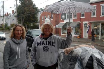Mindy Starr Pfahler and Hoper Prentice protect their pumpkin with an umbrella. ART MAYERS/Boothbay Register