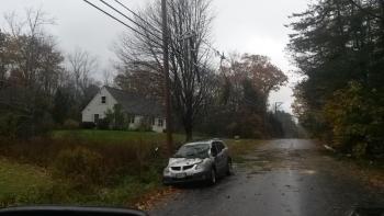 This car traveling the Ducktrap Road in Lincolnville had a tree topple onto it. (Photo courtesy Mike Eugley)