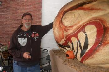 Glenn Chadbourne paints a giant pumpkin. ART MAYERS/Boothbay Register