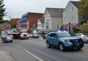 Brooklin Boat Yard transports a new 91-foot deck, constructed at Rockport Marine, in Rockport, over to Brooklin for finishing a new sloop. Escorted by the two state police vehicles, the convoy makes its way through downtown Camden early Sunday morning, Oct. 8. (Photo by Lynda Clancy)