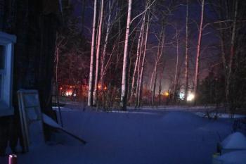 The back of the building was fully involved as seen from a neighbor’s home. (Photo courtesy of Rockport Fire Department)