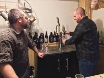 Dan Pangburn, left, and partner Nick Ullo, pour one of their beers on tap. SUZI THAYER/Boothbay Register