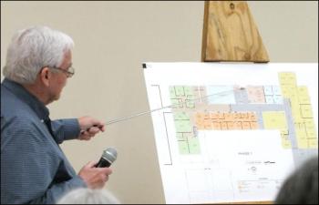 Architect John Hansen explains areas that would house municipal offices. gray areas would be public areas. Yellow would be town offices, orange police and blue the food pantry. The green area is the proposed phase two to house fire and EMS.