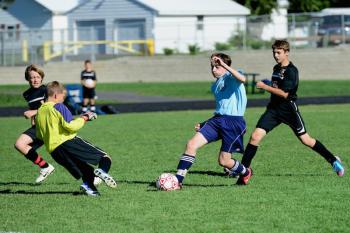 Pen Bay 14U player Morgan Mercier, center, puts a move on the Brewer goalie for a score during a 2012 game in Brewer. (Courtesy Bruce Jordan)