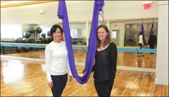 Betsy Kingsley and Jacquie Chamberlain stand beside the AntiGravity hammock Chaimberlain will demonstrate.
