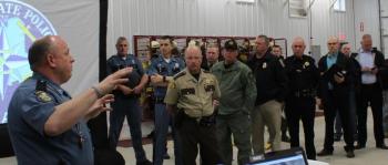 Lt. Mark Brooks, commanding officer of Troop C (Skowhegan) gives officers an update on the April 26 events with Lt. Col. John Cote and Somerset Sheriff Dale Lancaster in the background, among others. (Photo courtesy Maine Office of Public Safety)