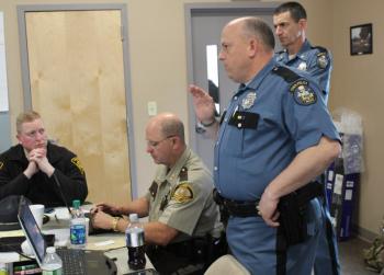 Lt. Brooks, Sheriff Lancaster, Lt. Col Cote and Penobscot Sheriff Troy Morton at the command post, inside the fire station. (Photo courtesy Maine Office of Public Safety)