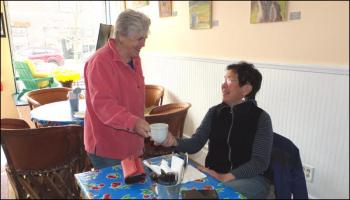 Barlow serves a cup of coffee to Pat Ryan, of Cushing. “I love it. It’s very cheerful and accommodating for the area. You can get a cup of coffee to go or just sit for a while,” she said.