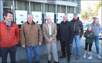 Dick Sampson, Jim Polky, Richard Bates, Jerry Hall, Ken Oelberger, Madeline MacCaffray and Maggie Gill throw the switches to turn on the solar power system.