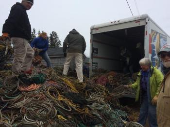 Pilot Gus Lookner, Kim Peabody, lobsterman Nat Hussey, Sue Liebling, and lobsterman Joe Bray help load the truck. (Photo by Eva Murray)